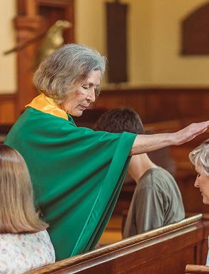 a woman is giving blessing to people